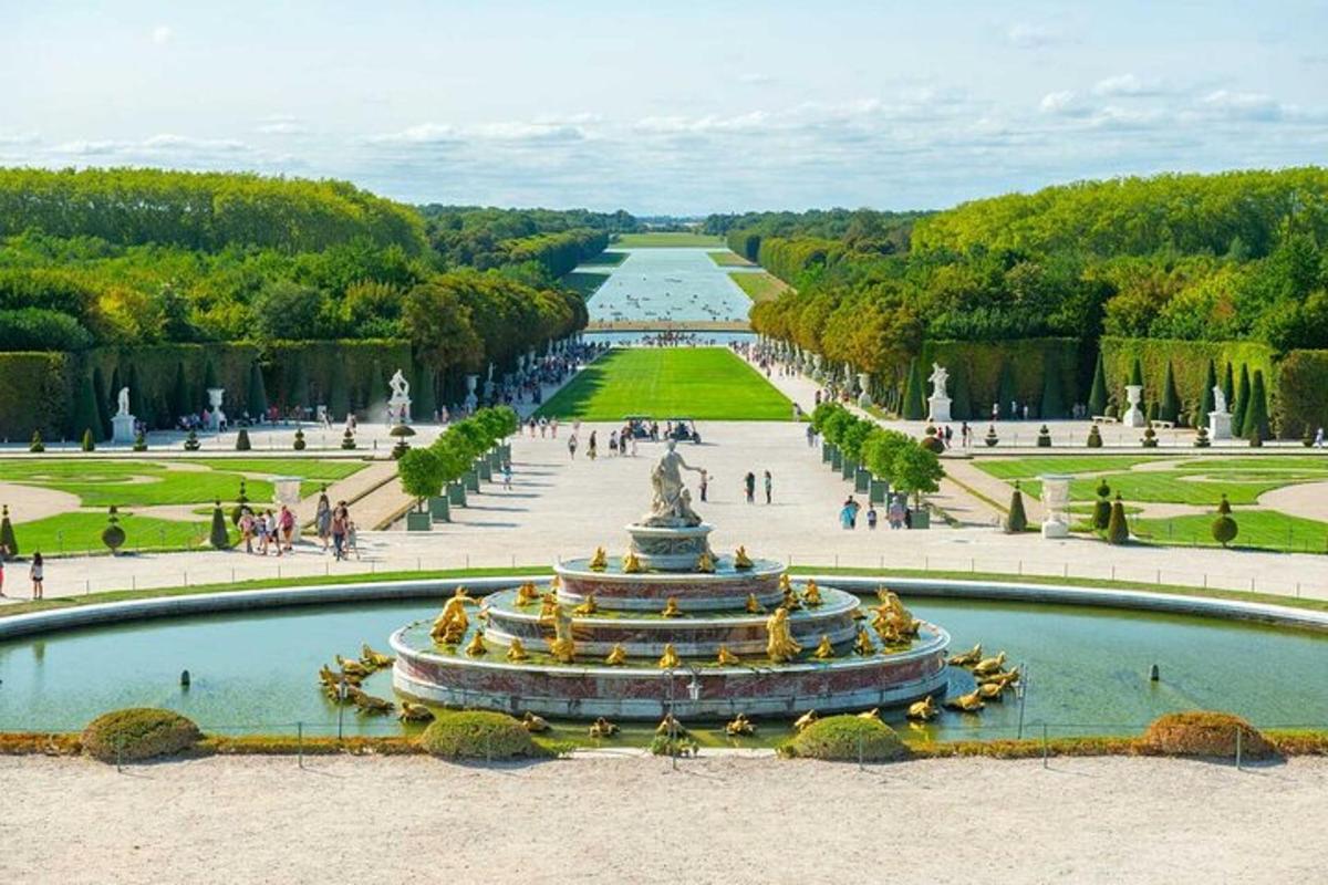 a view of a fountain in a park with a body of water