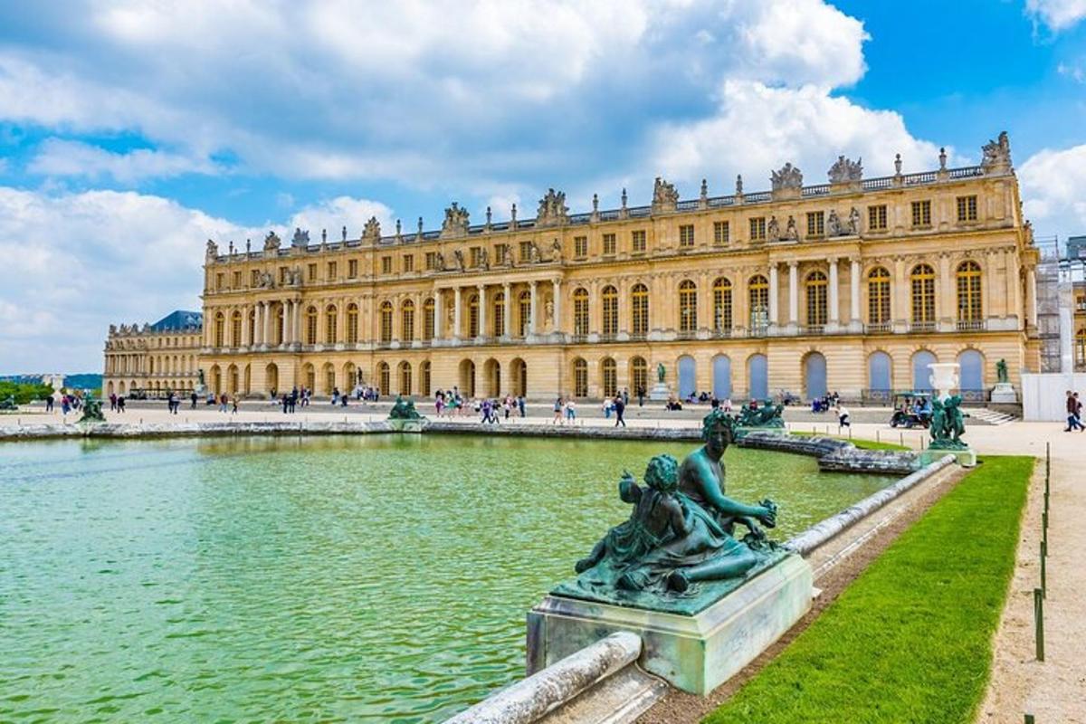 a statue in front of a large building with a water fountain