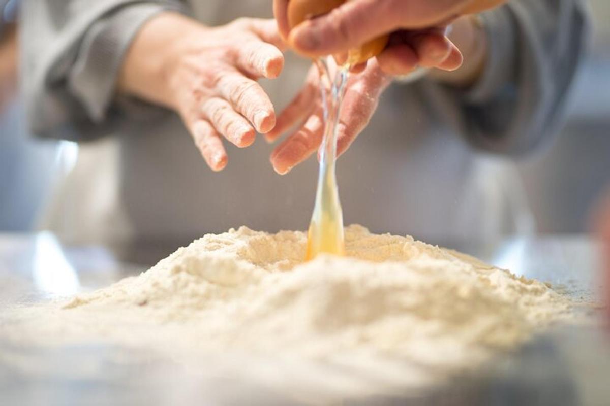 a person is pouring food into a pile of sand