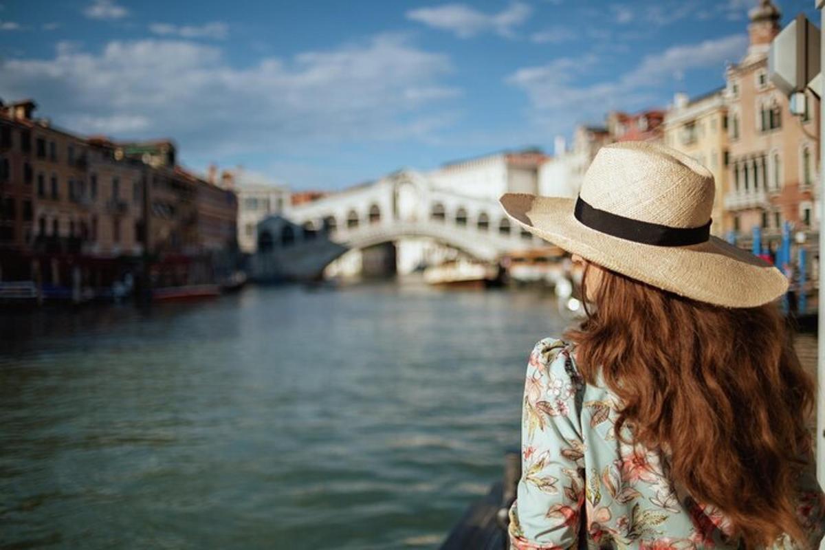 una donna che indossa un cappello e guarda un fiume