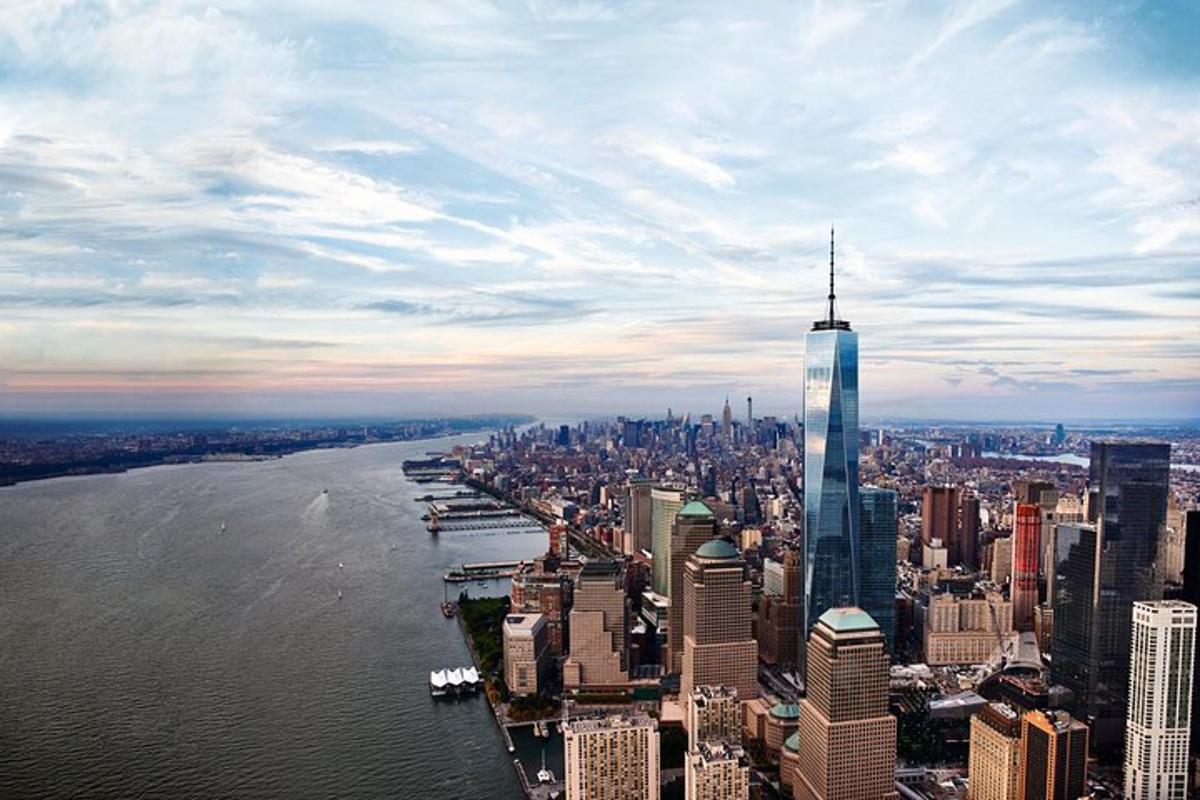 an aerial view of a city with a tall skyscraper