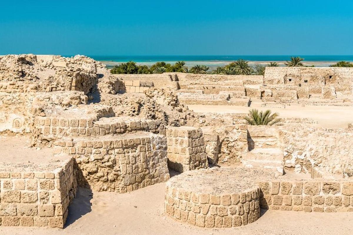 a large stone building in front of the beach