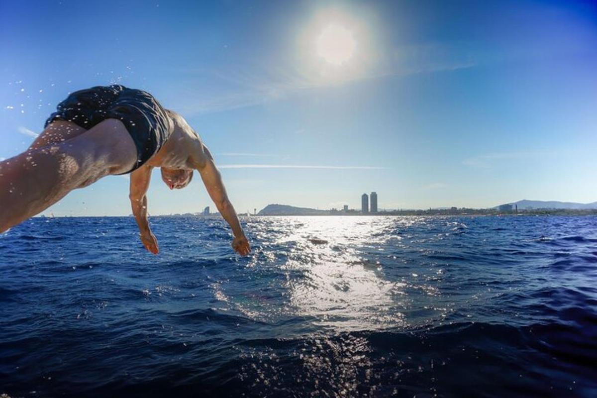 a man jumping into the water from a boat