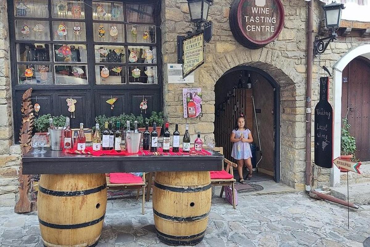 a woman standing in front of a wine tasting center