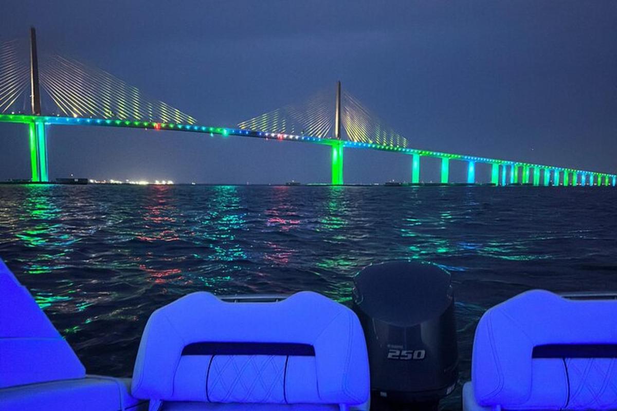 eine Brücke mit grünen und grünen Lichtern auf dem Wasser
