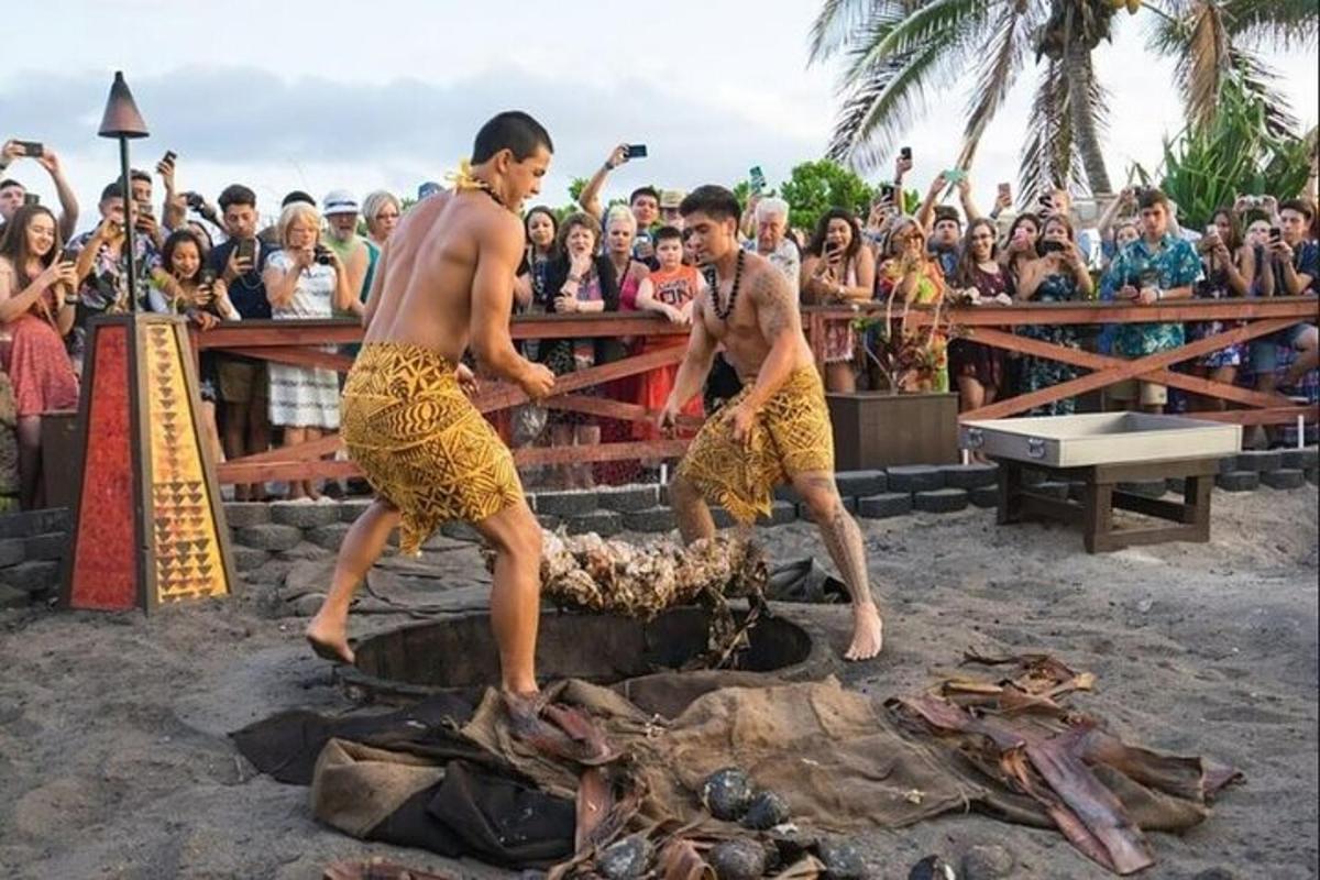 two men standing over a dead animal in front of a crowd