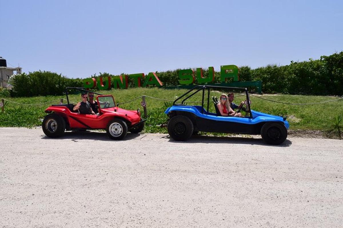 two people riding on a ride in a toy car