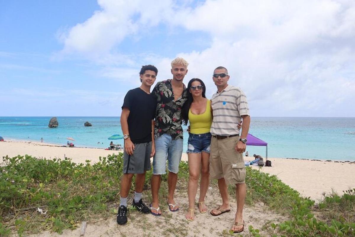 a group of people standing at the beach