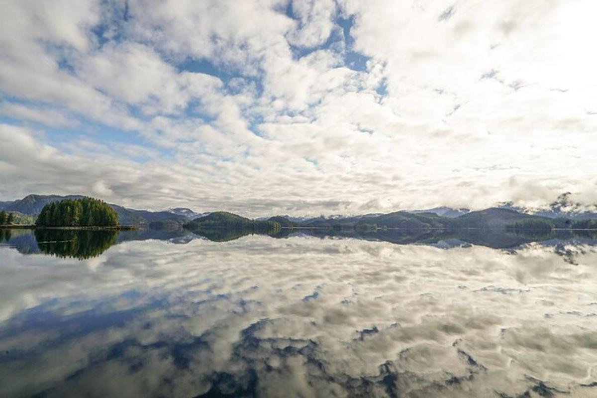 a large body of water with a cloudy sky
