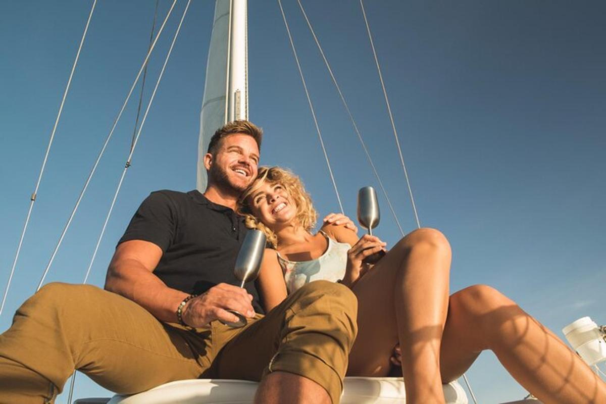 a man and woman sitting on a sail boat