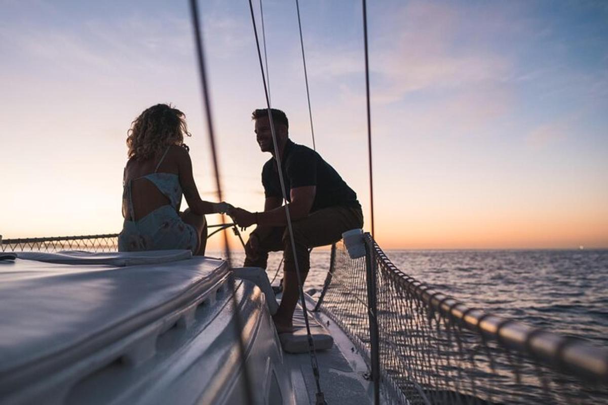 a man and woman sitting on a boat in the ocean
