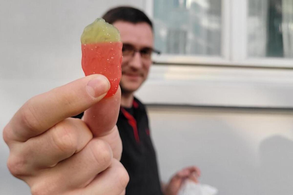 a man is holding up a piece of food
