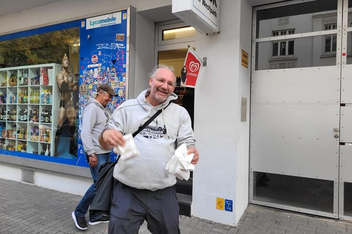 an older man walking in front of a store