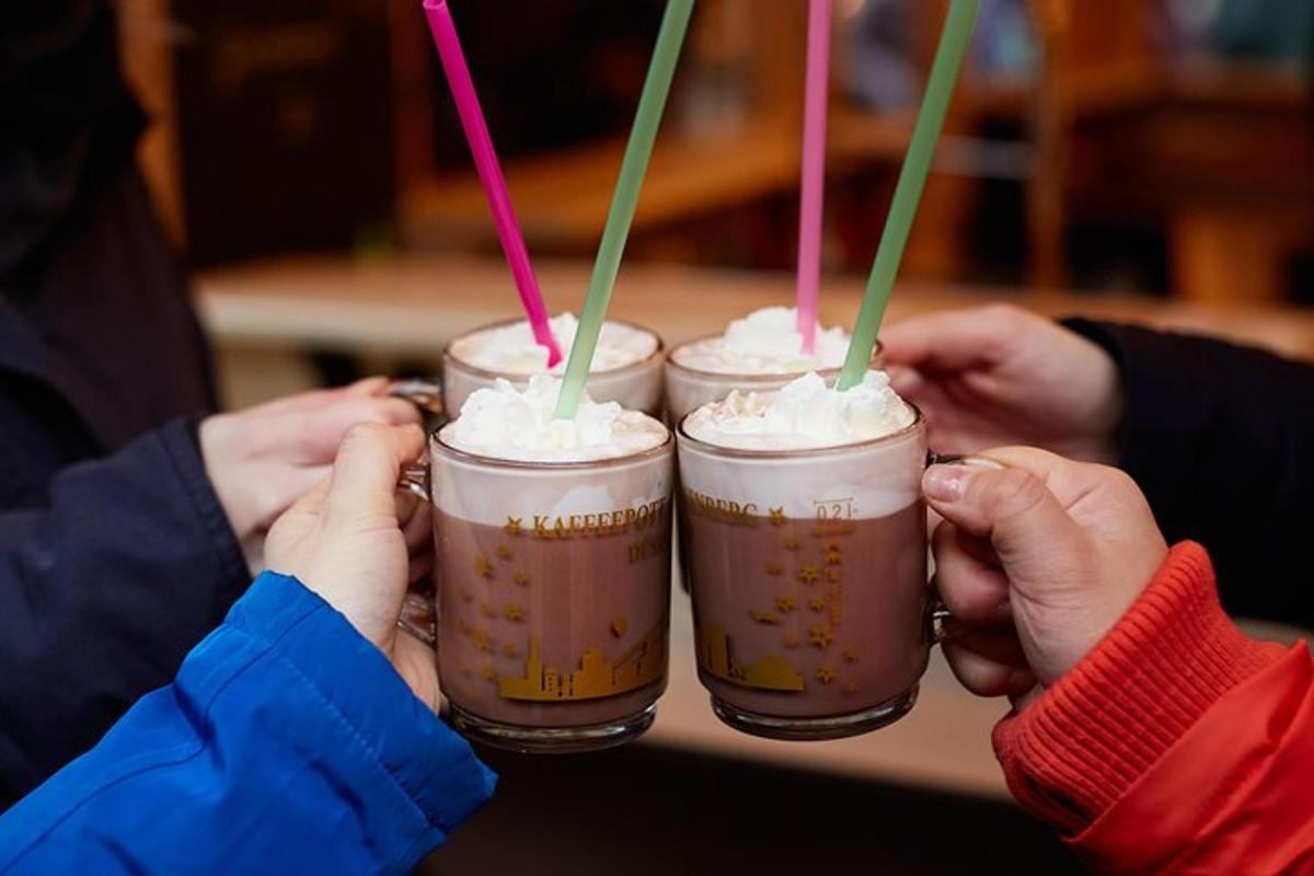 a group of people holding up three drinks with straws