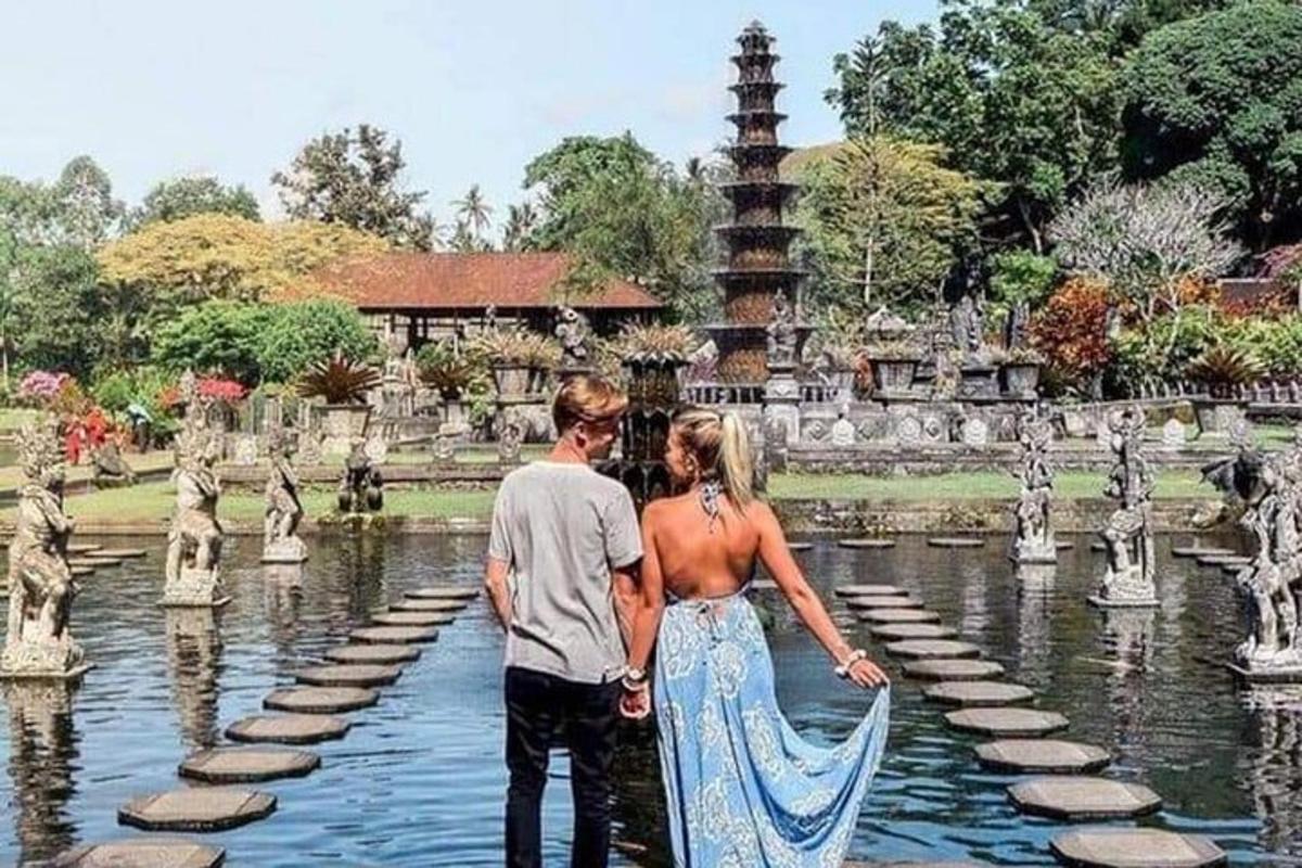 un uomo e una donna in piedi nell'acqua davanti a una fontana
