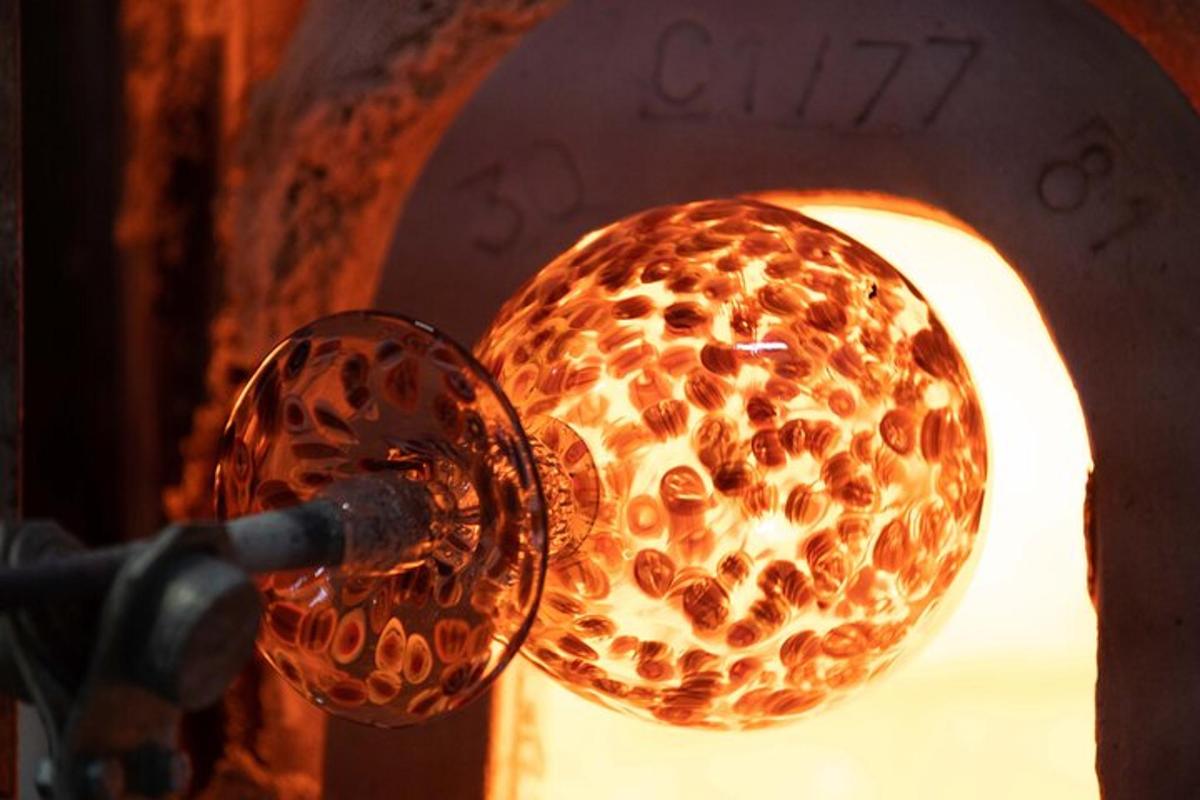 a close up of a wine glass hanging from a lamp