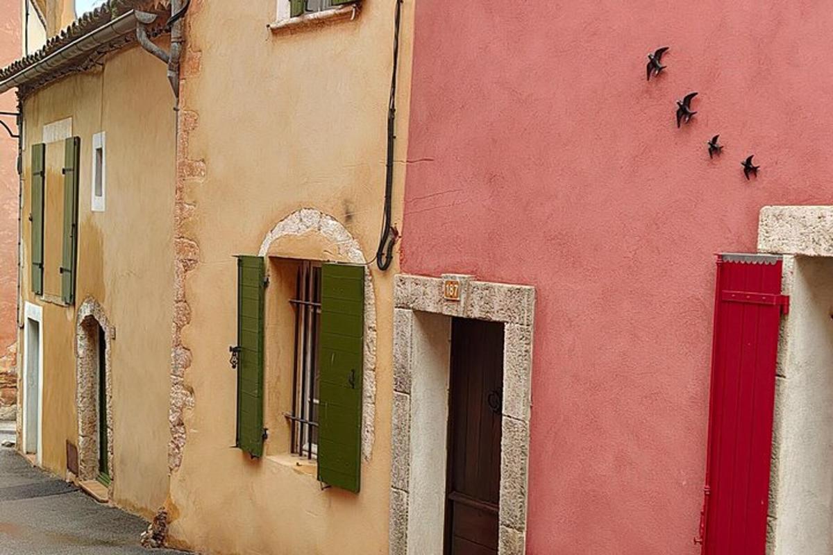 a building with green and red doors and windows