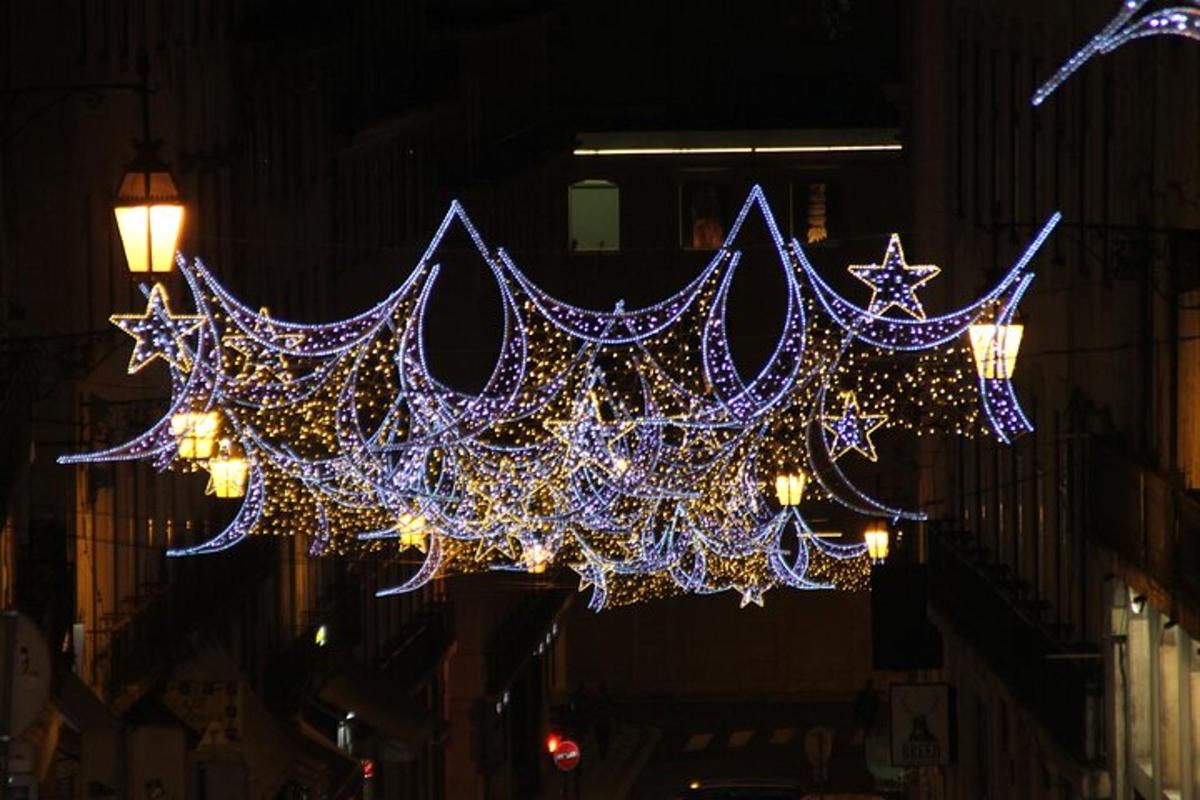 a bunch of lights hanging over a street at night