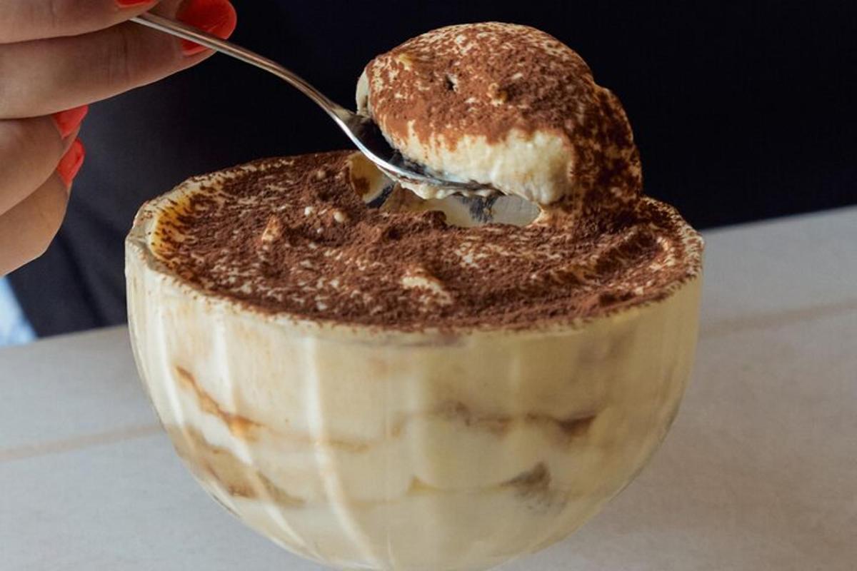 a person is eating a dessert with a spoon