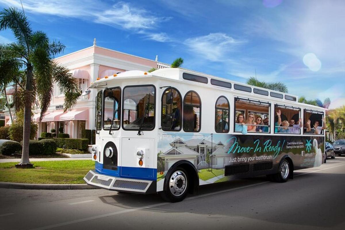 a bus driving down a street with people inside