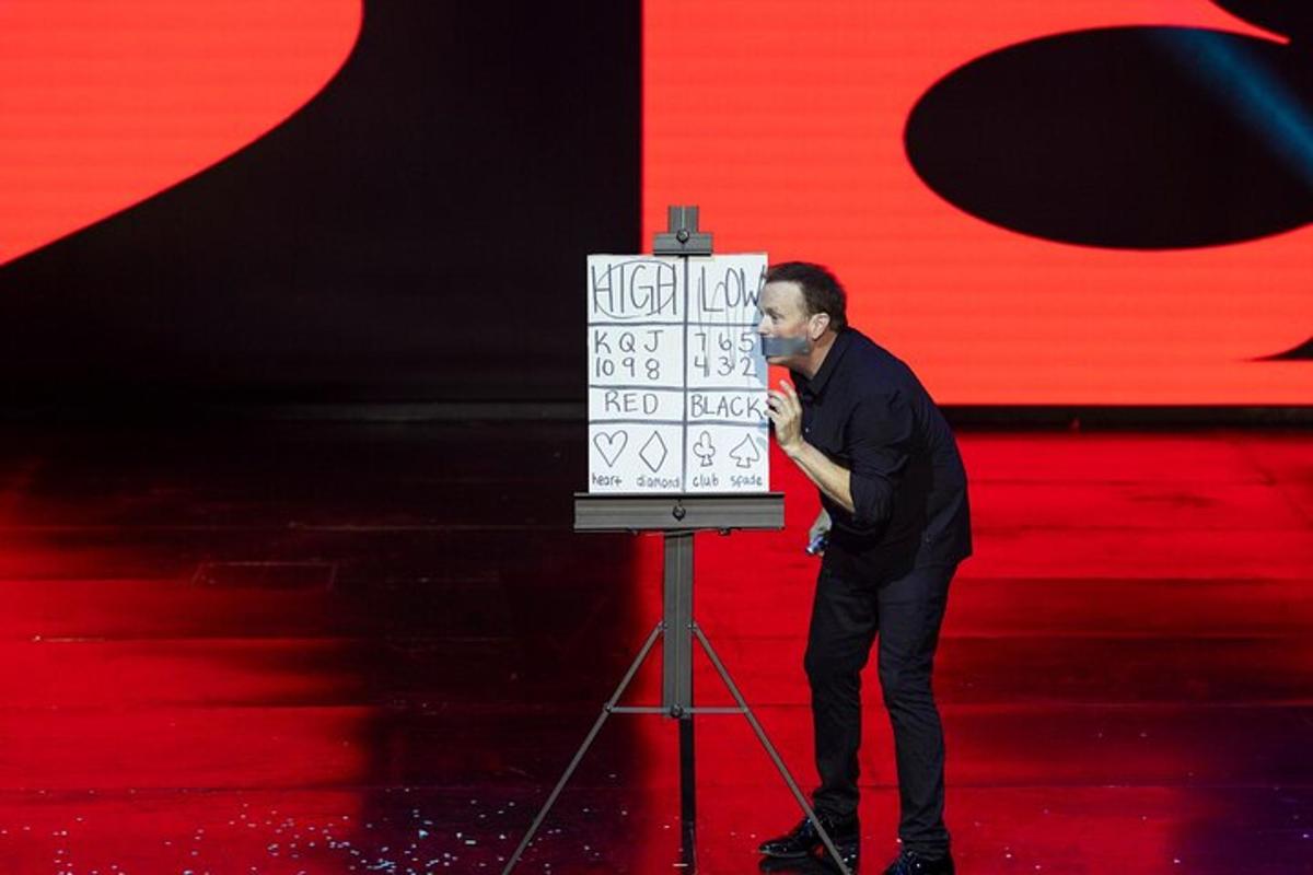 a man standing in front of a box on a stage