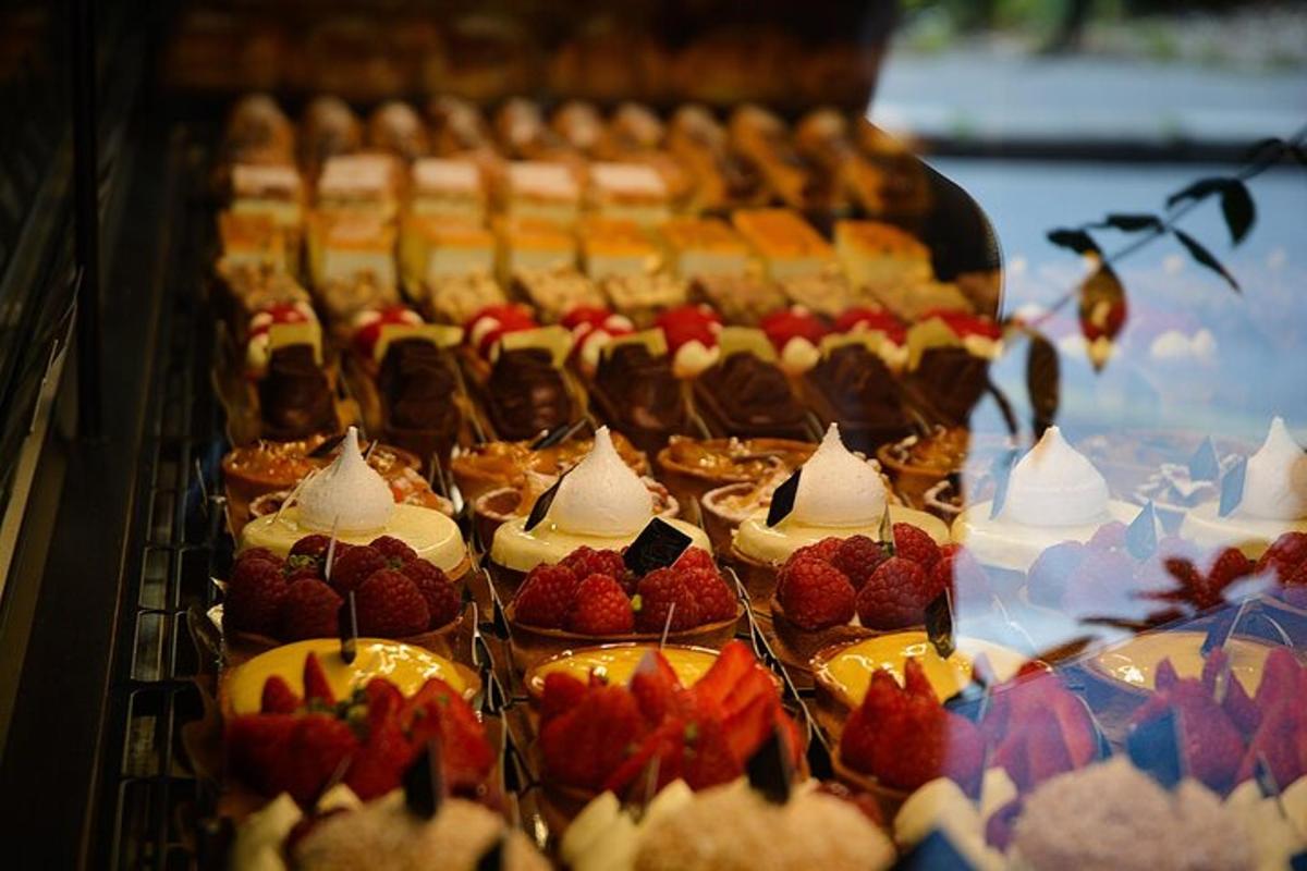 a display of cakes and pastries with strawberries on them
