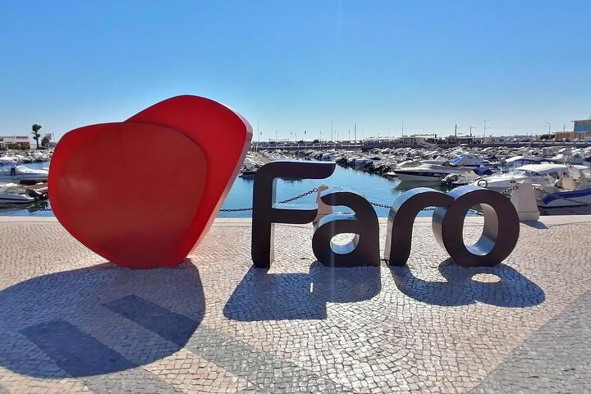 a red heart and the word love in front of a marina