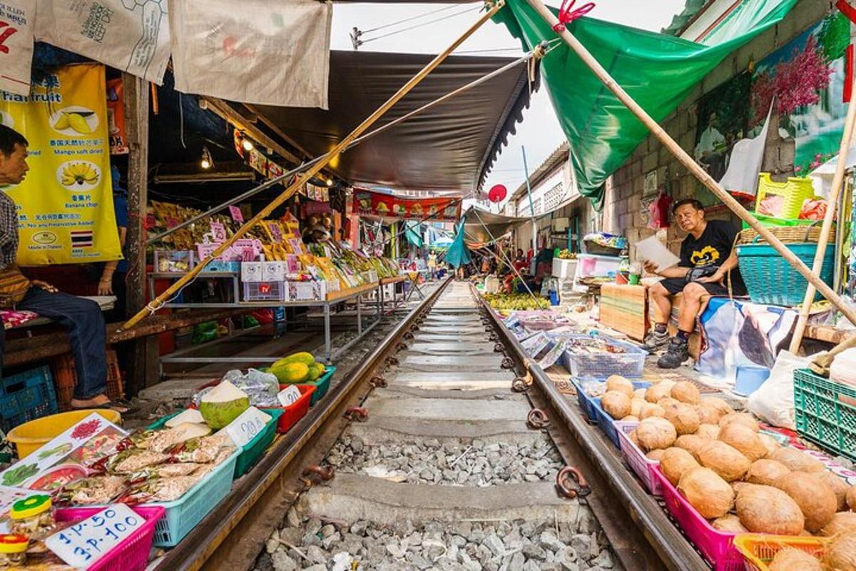 a market with fruits and vegetables on the tracks
