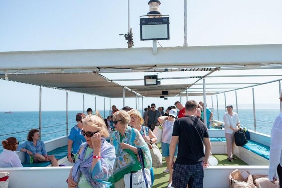 a group of people on a boat on the ocean