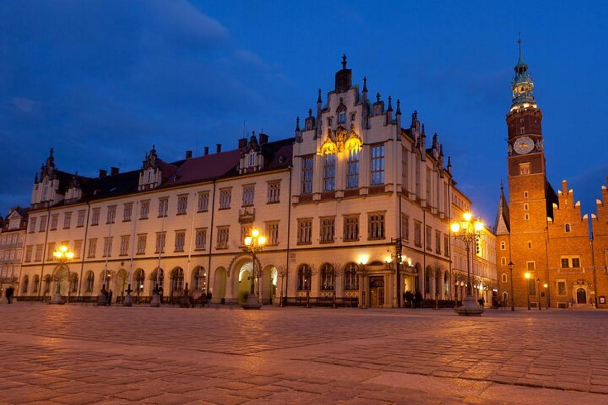 a large building with a clock tower at night