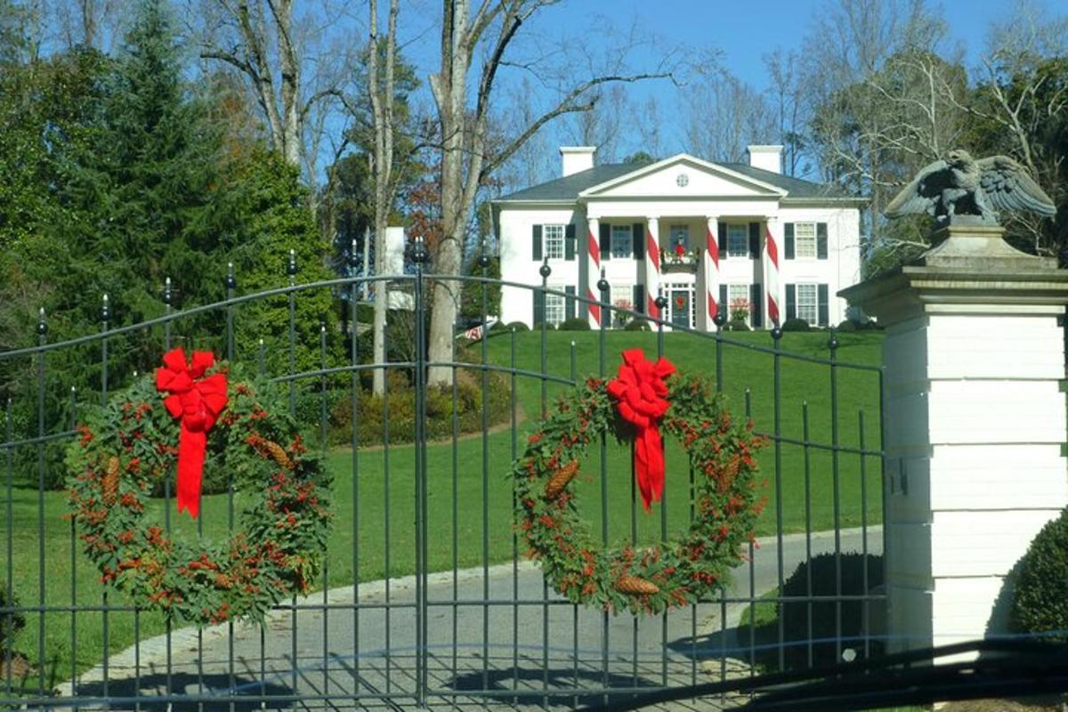 two wreaths on a fence in front of a house