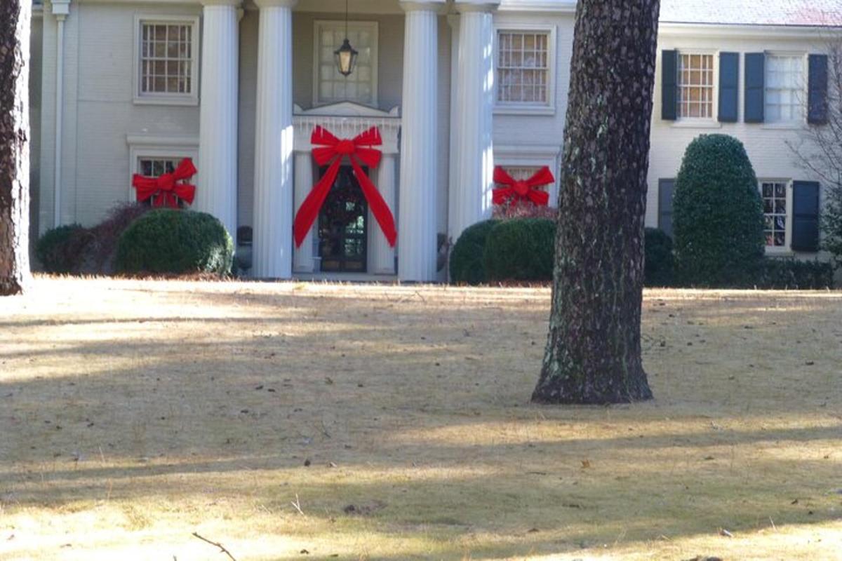 a white house with red bows on the doors