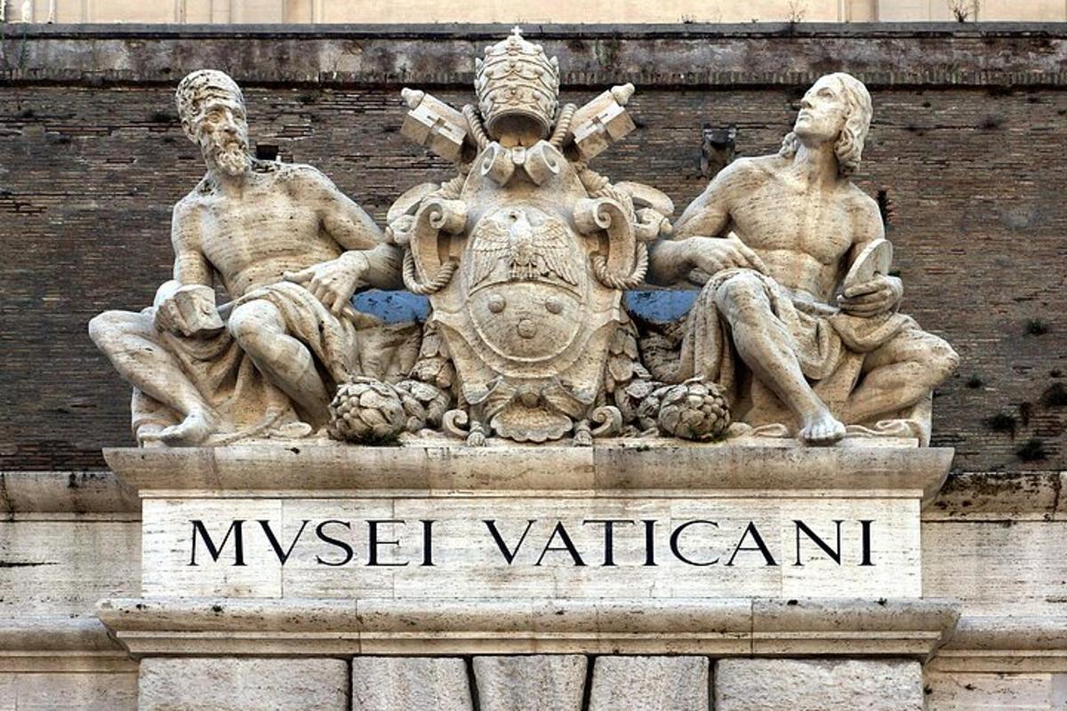 a statue of three men sitting on top of a building