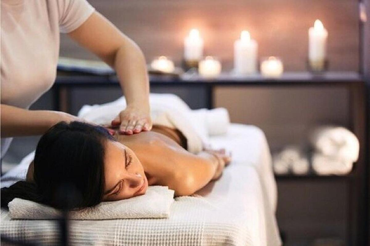 a woman getting a back massage at a spa