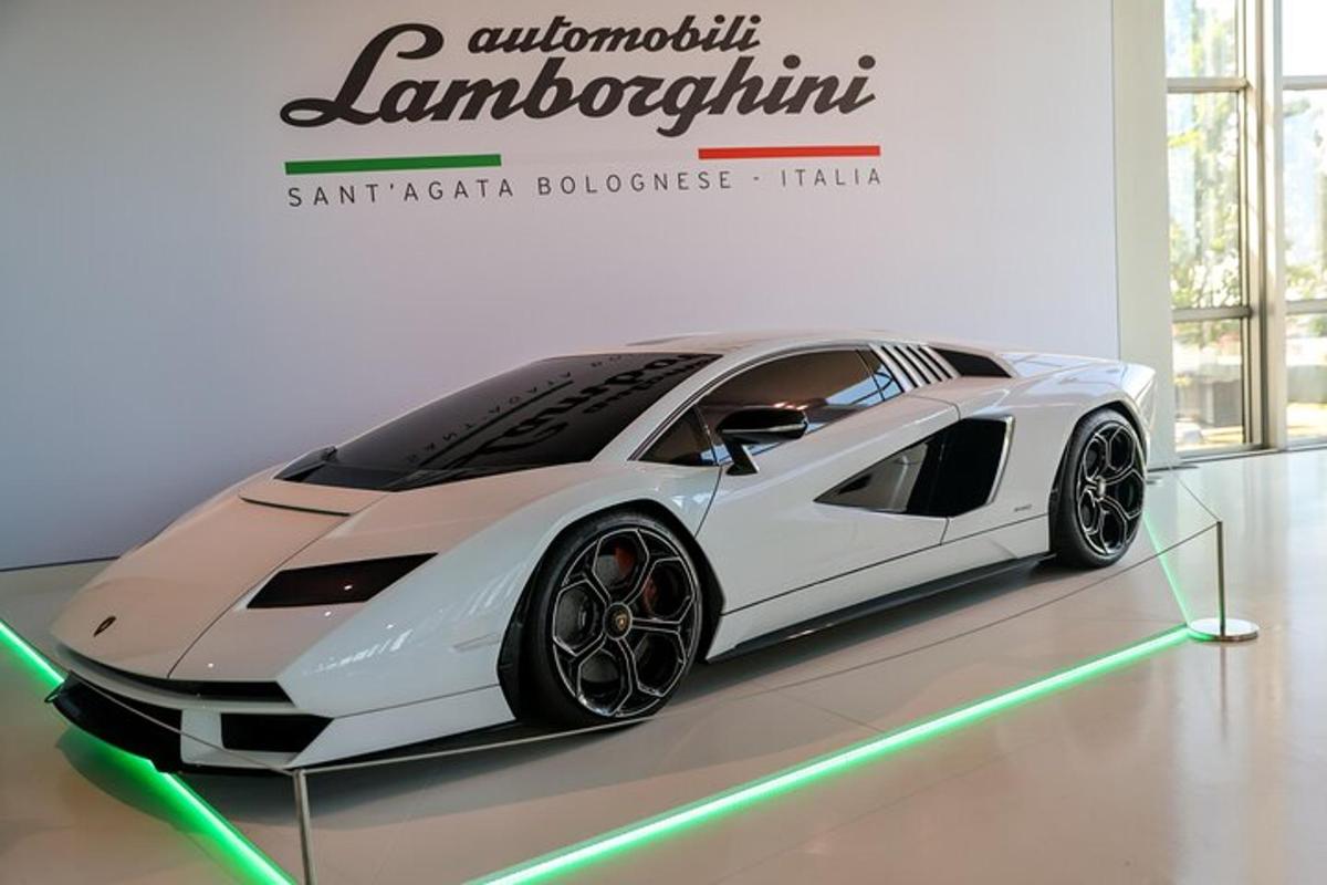 a white car is on display in a room