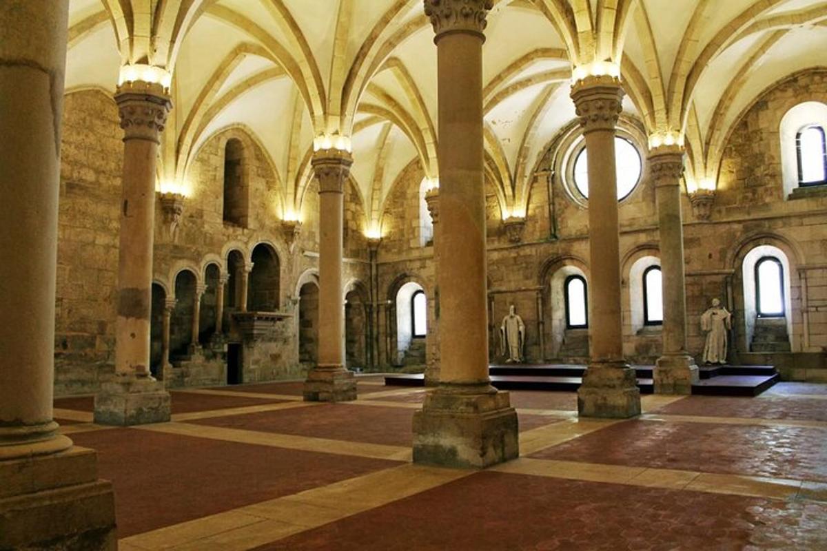 a large room with columns and arches in a building