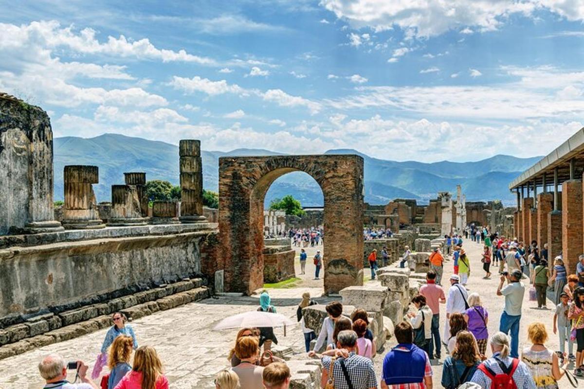 una folla di persone che camminano tra le rovine del Theiseum