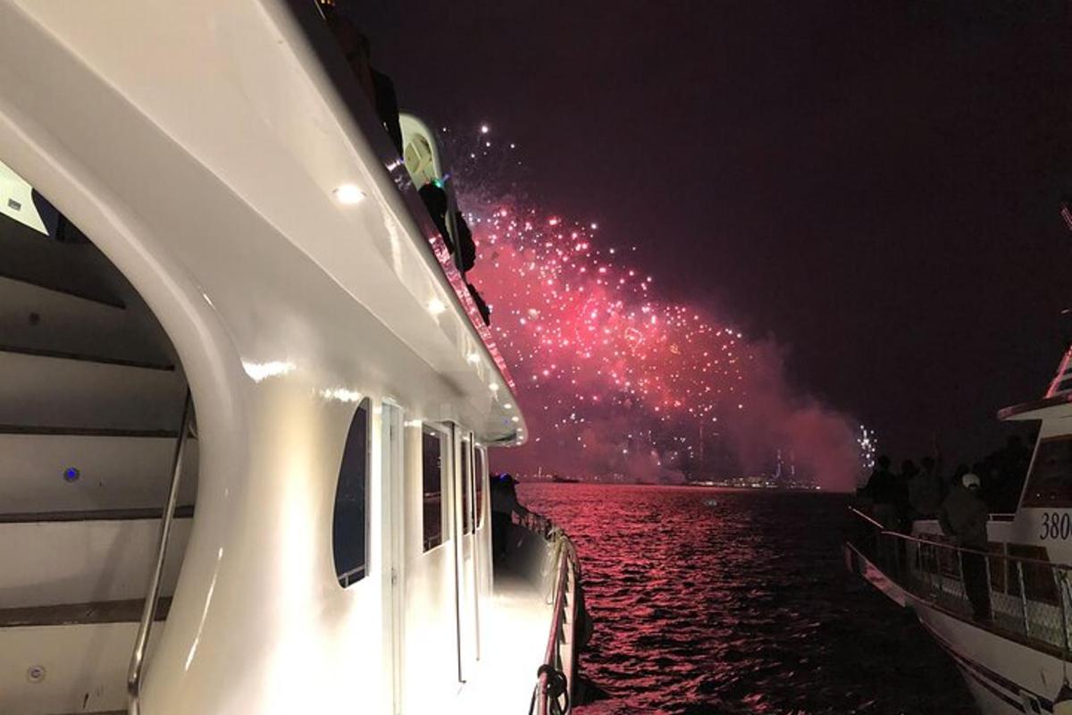 a boat with fireworks in the water at night