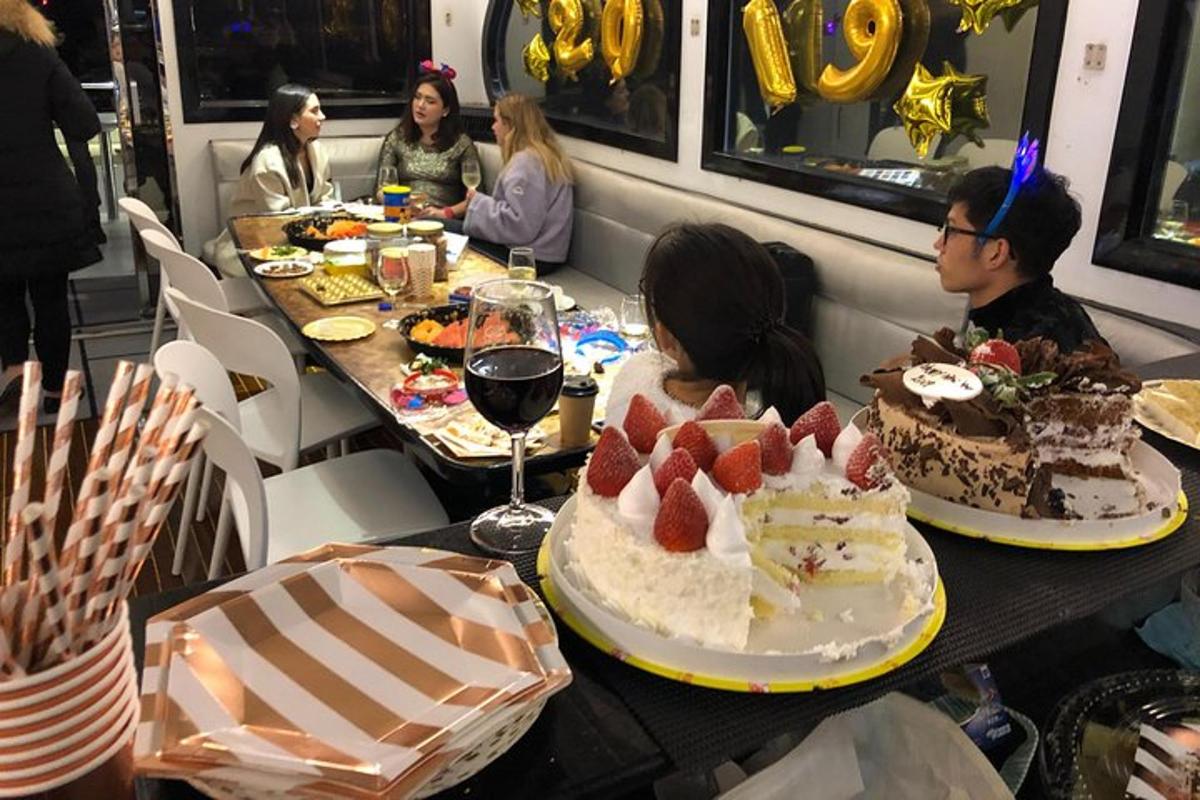 a group of people sitting at a table with cakes