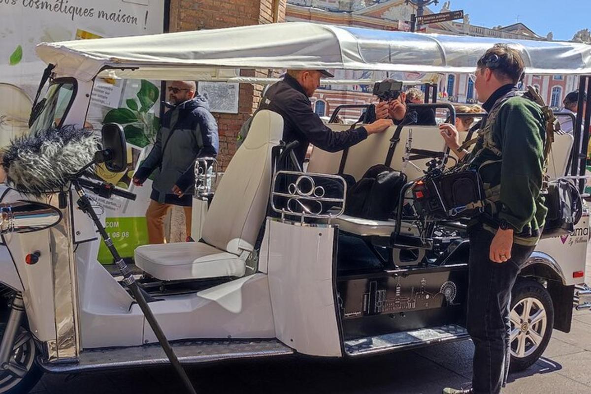 un uomo in piedi sul retro di un golf cart