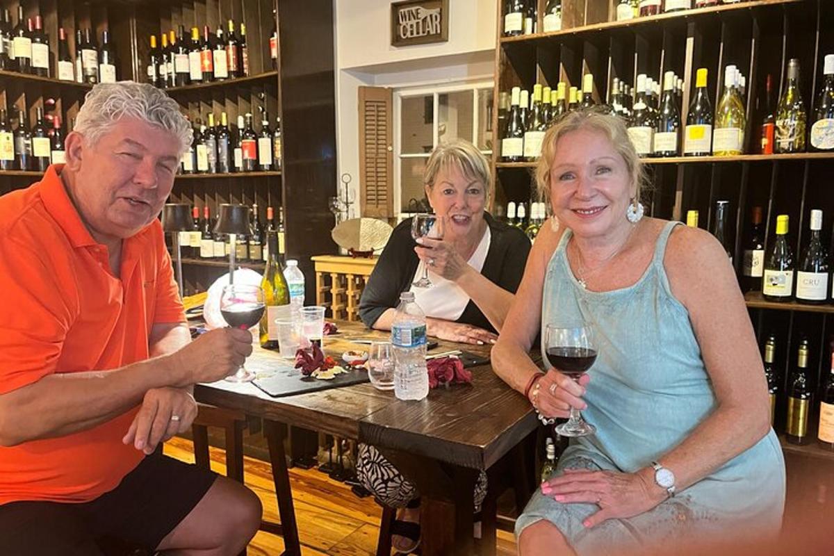 three people sitting at a table in a wine bar
