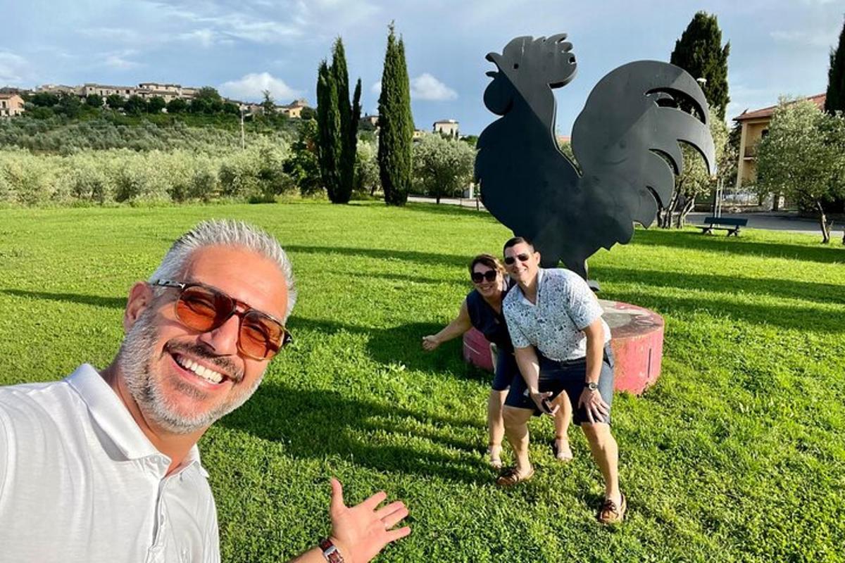 a man standing in front of a statue of a bird