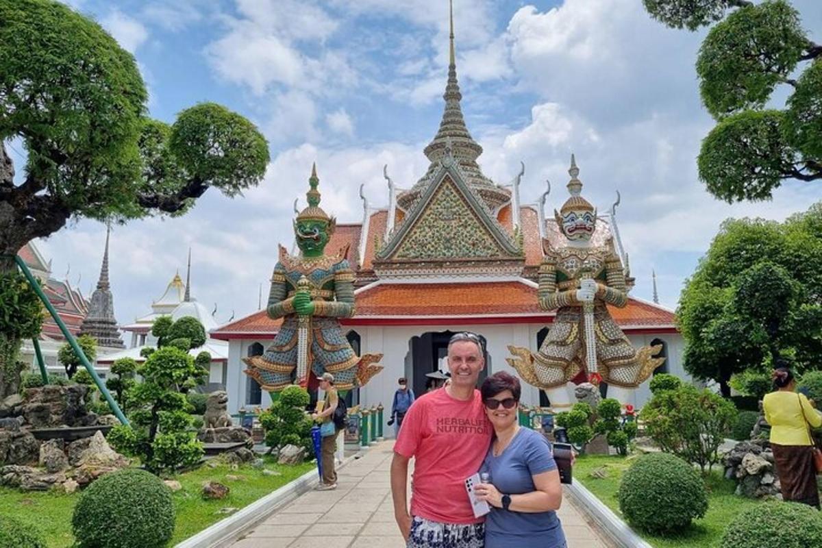a man and a woman standing in front of a building