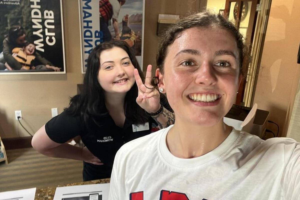 a woman is making a peace sign with a young boy