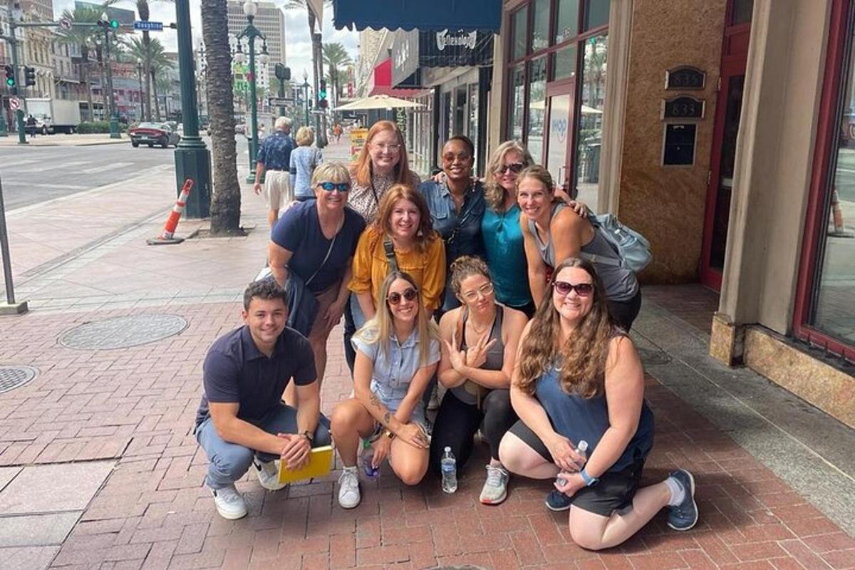 a group of people posing for a picture on a sidewalk