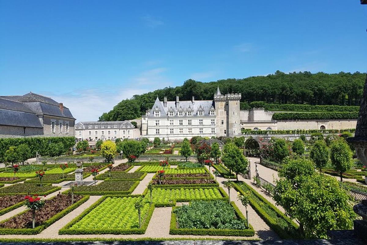 a view of a garden in front of a castle