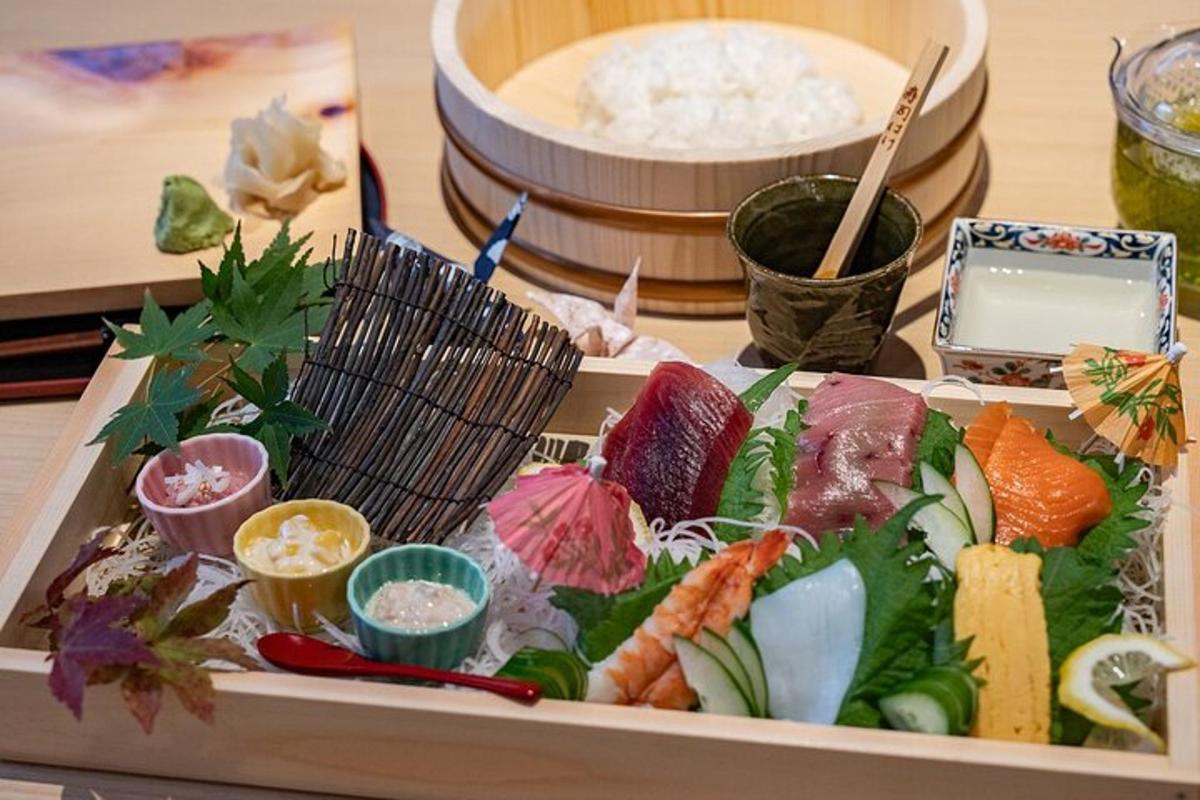 a tray of food with sushi on a table