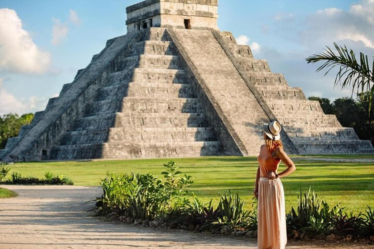 a woman standing in front of a pyramid