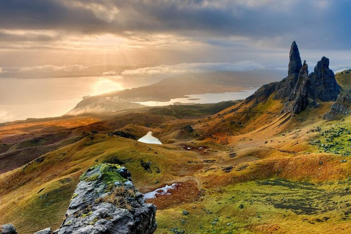 a view of a mountain with a sunset in the background