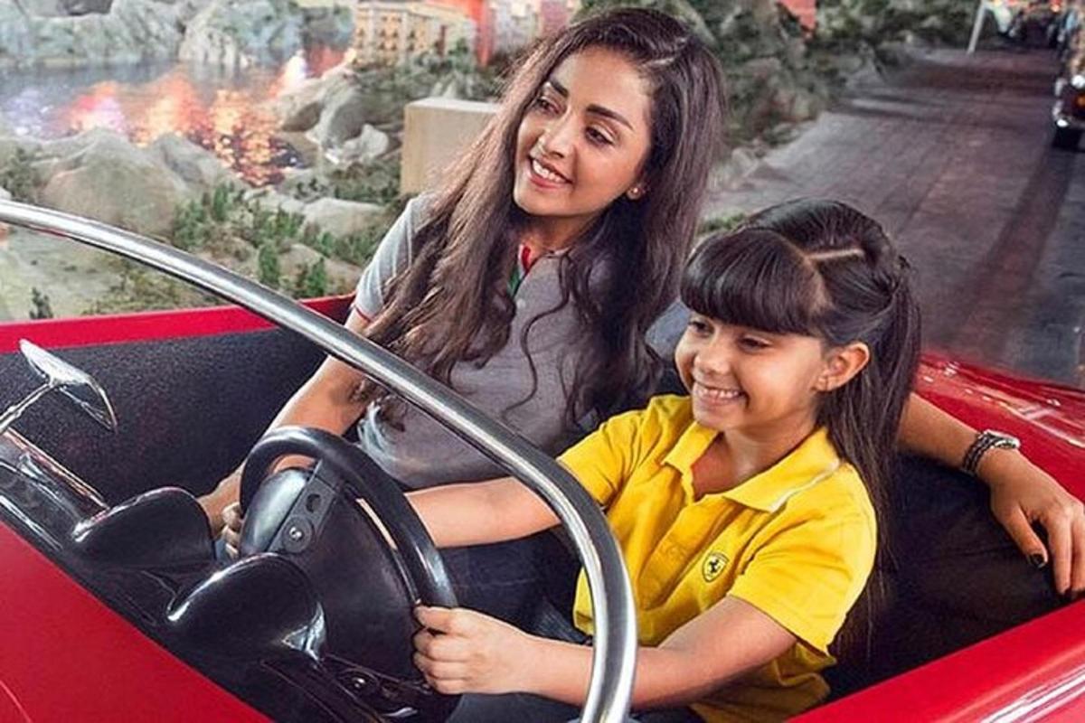 a woman and a child sitting in a car